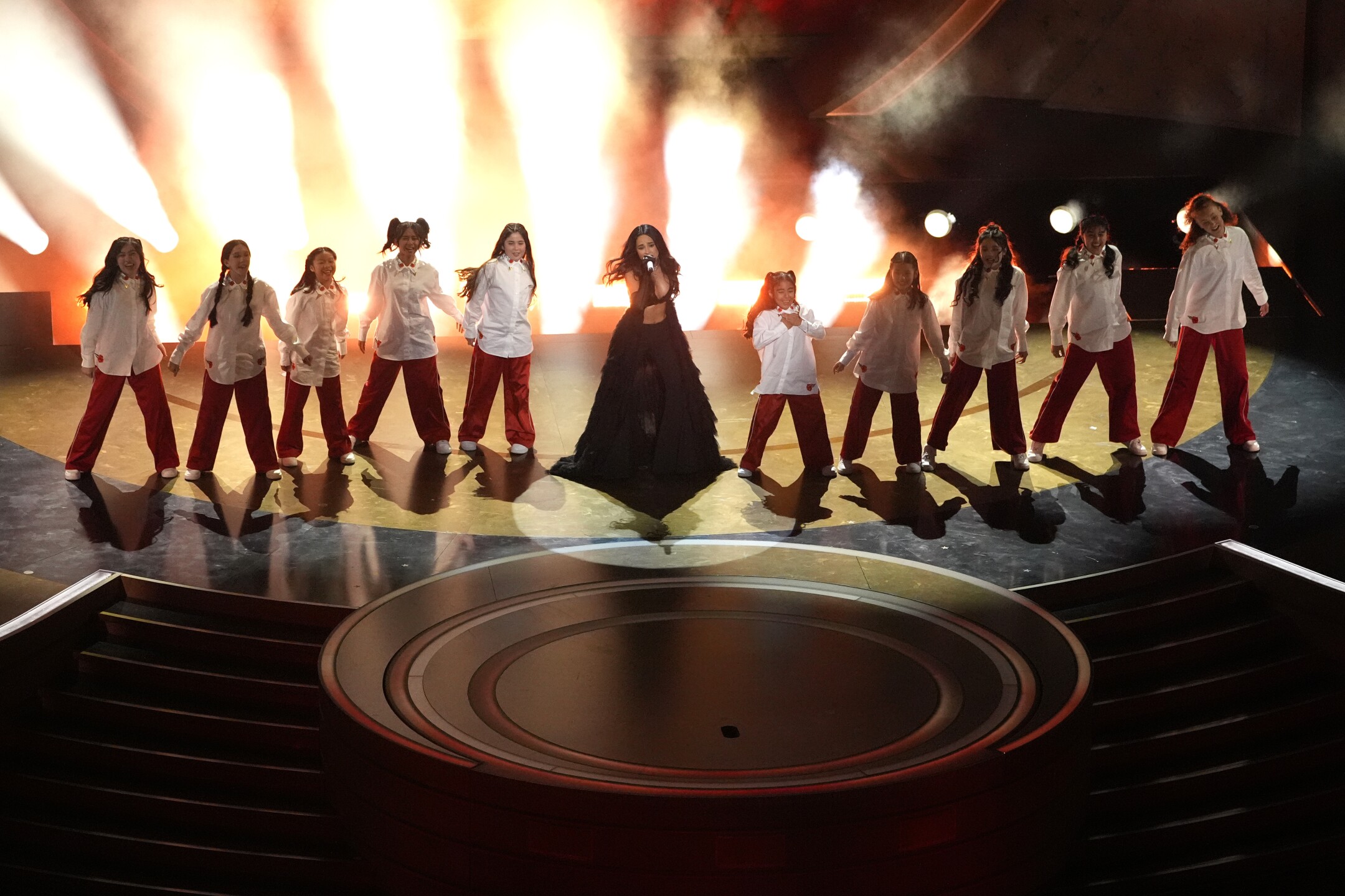 Becky G, center, performs the song "The Fire Inside" from the movie "Flaming Hot" during the Oscars on Sunday, March 10, 2024, at the Dolby Theatre in Los Angeles. 