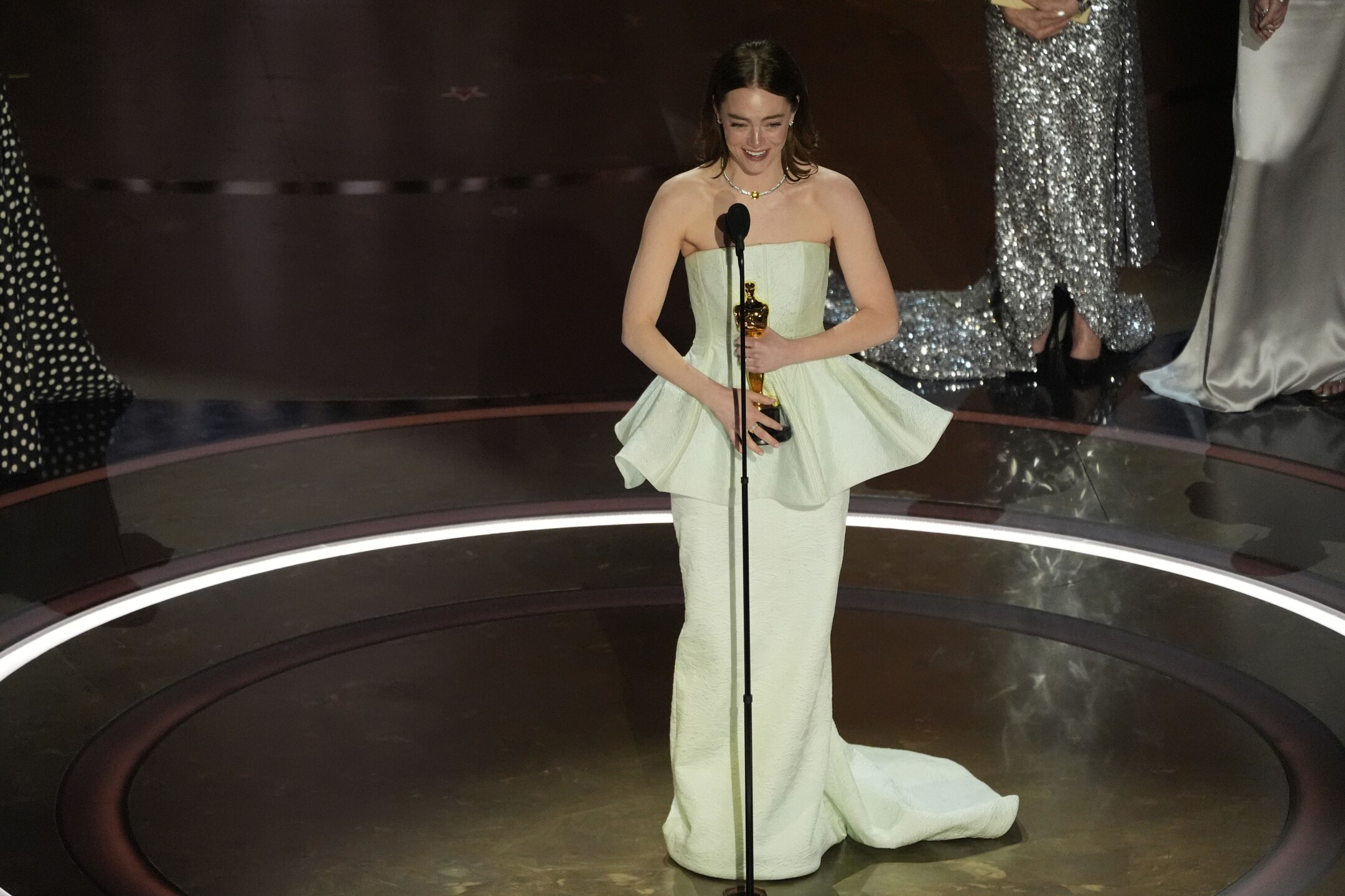 Emma Stone accepts the award for best performance by an actress in a leading role for "Poor Things" during the Oscars on Sunday, March 10, 2024, at the Dolby Theatre in Los Angeles. 